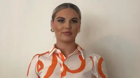 Sydney Miller Sydney Miller smiling at the camera.