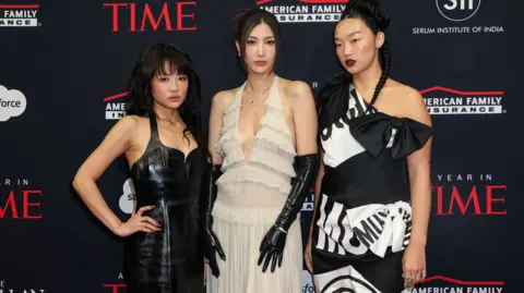 Reuters Rei Ami, EJAE and Audrey Nuna, singing voices of the members of the HUNTR/X group in "KPop Demon Hunters" animated movie, attend the red carpet for TIME's "A Year in TIME" event in New York City, December 10, 2025