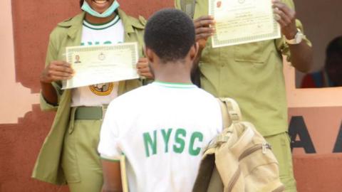 National Youth Service Corps (NYSC) members pose with their certificates