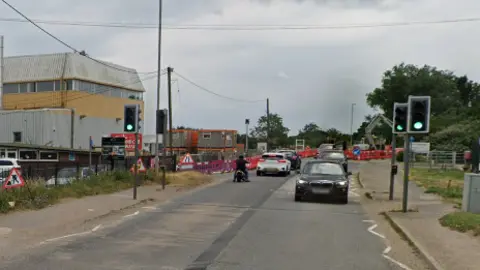 Google street view of Broadway in Yaxley with traffic lights on either side 