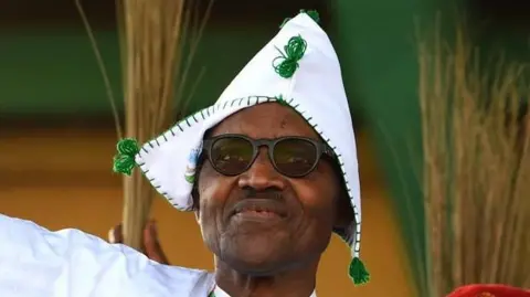 Pius Utomi Ekpei/ Getty images Former Nigeria president Muhammadu Buhari wearing eye glasses and a traditional hat