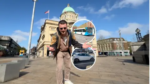 Josh Gorroño Chapman stands in Queen Victoria square in front of Hull City Hall, with the building’s domed roof and columns visible behind him. Two circular cut-out images show a bus and a car.