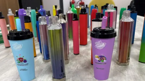 A selection of confiscated illegal vapes of all colours and sizes