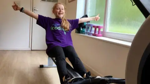 Family handout Image of Luna on a rowing machine. 