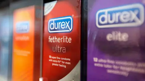 Packets of Durex fetherlite condoms, produced by Reckitt, on a supermarket shelf.