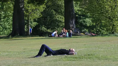 Getty Images A man pictured sunbathing in Roundhay Park.