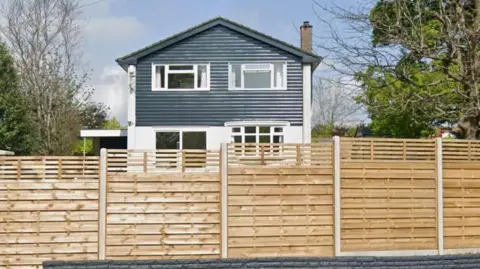 A house in Chepstow surrounded by a wooden fence