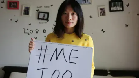 Getty Images Sophia Huang Xueqin holds a sign reading MeToo