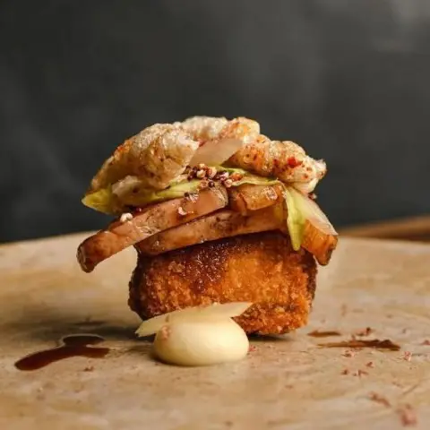 Instagram/Gwen restaurant A plate with pork on it 