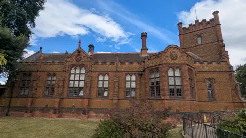 James Goodman-Stephens Beautiful old fashioned building which houses King's Lynns Library. It is dark honey coloured stone with lots of windows. 