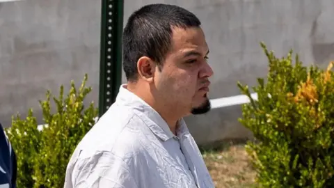 Man in grey shirt