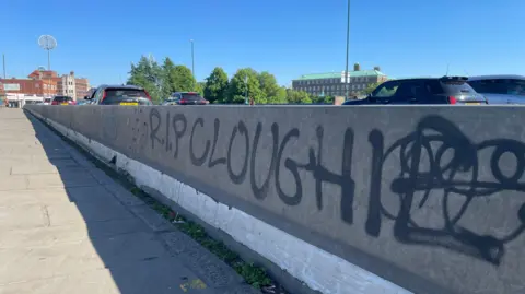 BBC Graffiti on a barrier going across Trent Bridge