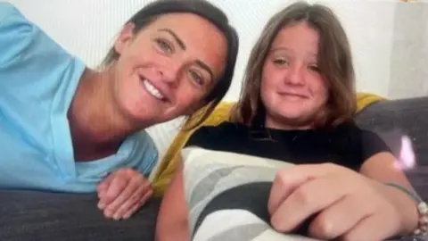 Jo and her daughter Erin say at home taking part in the book club session via a computer videolink