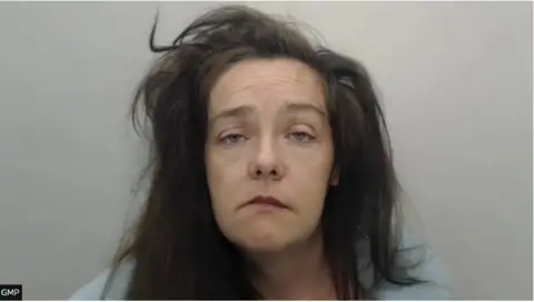 Police mugshot of Claire Scanlon, who has unkempt long brown hair. She stare impassively at the camera.