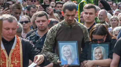 Getty Images Hundreds of people attend the funeral of political and social activist, linguist Iryna Farion at the Garrison Church of the Holy Apostles Peter and Paul in Lviv, Ukraine, on July 22, 2024.