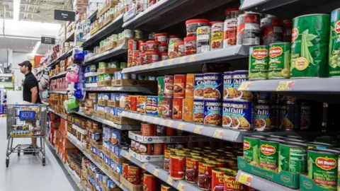 Getty Images Miami, Florida, Hallandale Beach, Walmart store, Del Monte, Armour and Hormel canned goods aisle with shoppers