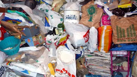 Piles of bags and newspapers