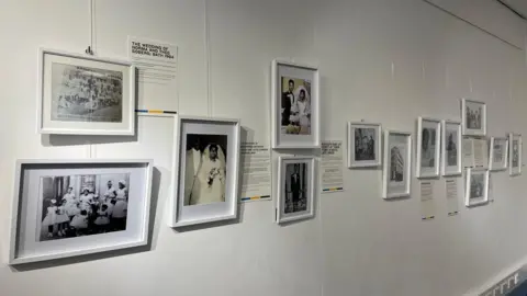 A photo shows an exhibition in Bath, with lots of old black and white pictures on the wall.