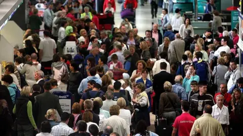 PA Media Long lines of people waiting to check in at Dublin airport

