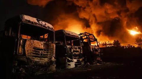 Fire breaks out at the Shahran oil depot after US and Israeli attacks, leaving numerous fuel tankers and vehicles in the area unusable in Tehran, Iran on March 8, 2026.