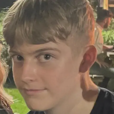 Martell Blackford Jacob Holman in a picture. He is a young boy with a short back and sides style haircut. He is smiling and looking at the camera. 