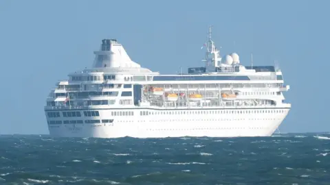 Pacemaker Villa Vie Residences' Odyssey, pictured in Belfast Harbour on Tuesday - white cruise ship in water