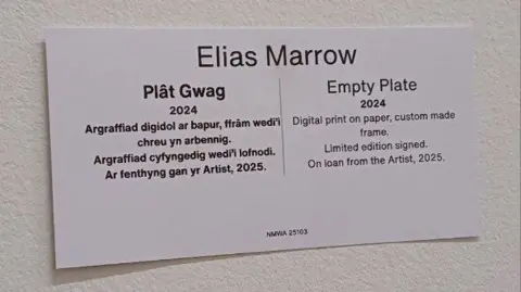 A close up of the label which says Elias Marrow Empty Plate 2024 inWelsh and in English