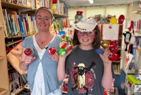 Rob Rose/BBC Mum Charlotte on the right and Ziggy on the left. They have a number of Comic Relief red noses on their fingers. 