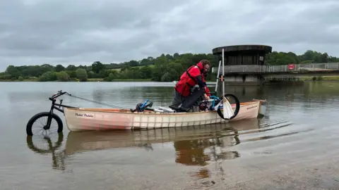 BBC/George Carden Ben Kilner in self-built amphibious bicycle canoe