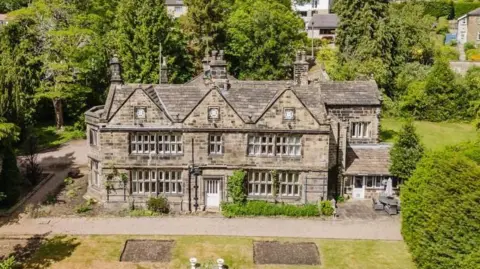 Holroyd's Estate Agents A large 17th century manor brick house. It was large grounds with lawns, trees and shrubs.