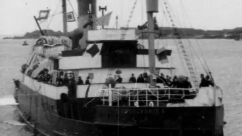 A black and white ship returning to Alderney following the Island's 5 year occupation.