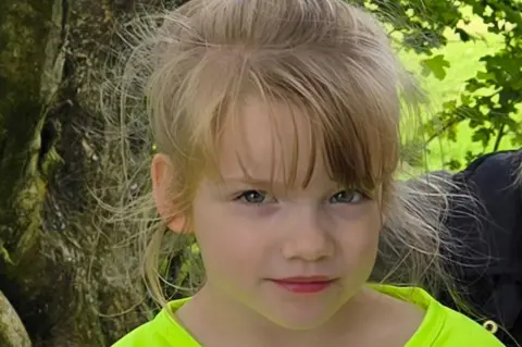 Police Scotland Hope looking directly at the camera. She is wearing a luminous green t shirt. She has blonde hair and blue eyes.