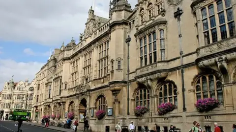 Oxford Town Hall is an ornate, historical, stone building with large first-floor windows.