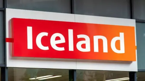 An Iceland store sign. The word "Iceland" is in white lettering on a red/orange background.