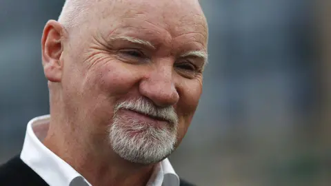 Getty Images A man with a white beard and moustache, and bald head. 