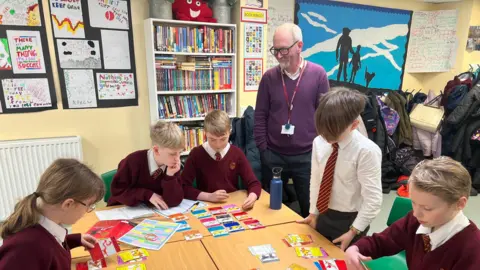 Stuart Howells/BBC The Year 6 pupils playing their Doggy Cards