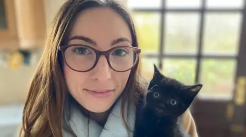 Rheanna Hazel Ms Hazel holding a cat