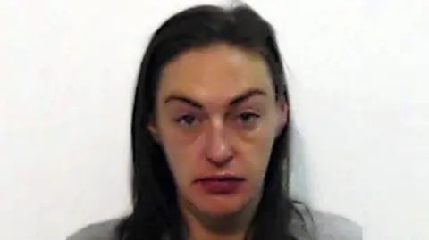 Police Scotland A police mugshot of Natasha Smith who is in her late 30s with long, brown hair