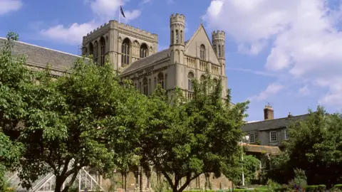 Peterborough Cathedral surrounded by trees. 