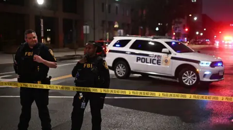 FBI agents cordon off the scene outside the Capital Jewish Museum following a shooting that left two people dead, in Washington, DC, in the early hours of May 22, 2025. 