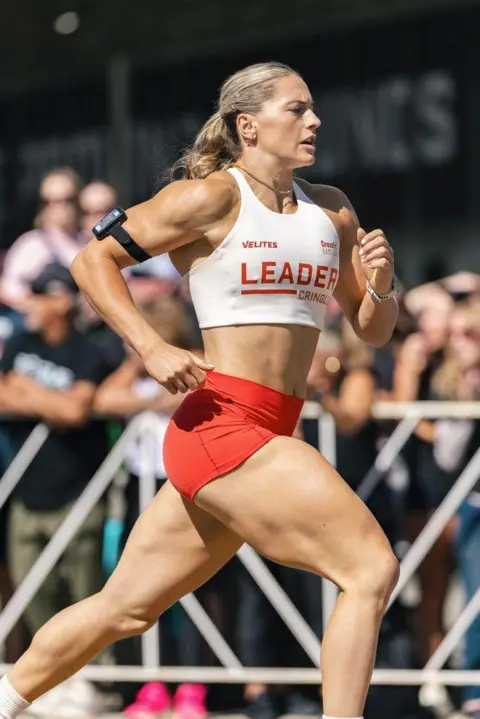 CROSSFIT GAMES Cringle running as crowds watch from behind a barrier.