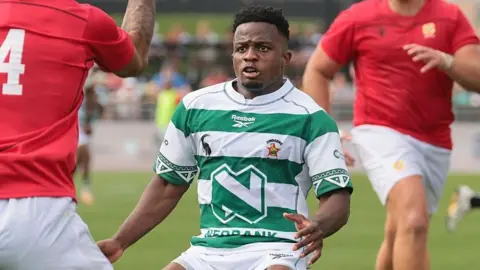 Edward Sigauke, wearing the green and white hooped shirt, in action for Zimbabwe in their Nations Cup match against Tonga in July 2026