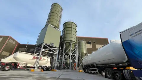 BBC A picture of Material Evolution's factory in Wrexham, also showing a mixing tower and industrial vehicles