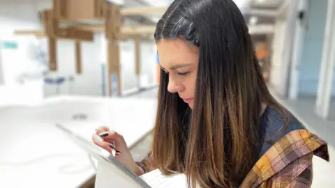 Emily uses her iPad to make a digital drawing