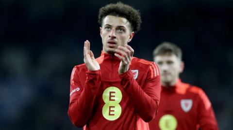 Ethan Ampadu applauds Wales' fans in the Euro 2024 play-off semi-final against Finland