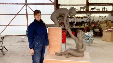 Kate Denton with the Because You Matter sculpture