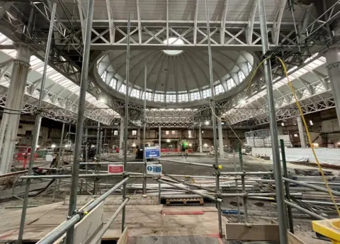 Scaffolding and a building site inside the General Market hall of Smithfield Market with the giant dome seen at the centre of the ceiling