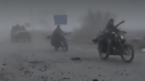 A foggy image of Russians on motor bike riding along a road in eastern Ukraine