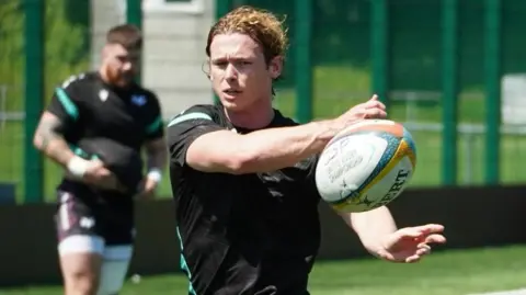 Harri Williams passes the ball in training