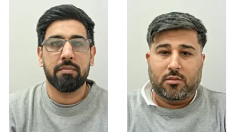 Kashif Mehdi (L) has dark hair and beard with spectacles. Rizwan Mehdi (R) has greying dark hair and beard. Both are wearing grey prison sweat shirts.